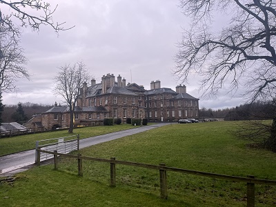 Photo of Buccleuch House in Dalkeith Country Park, with Chris from Pentland Locksmiths carrying out a door lock repair on the historic property.